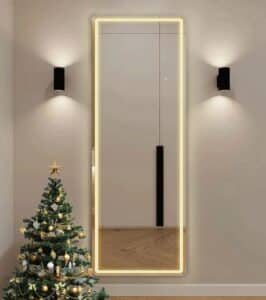 A sleek freestanding light mirror enhancing a modern bedroom decor.