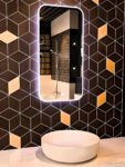 Luxury LED mirror in a high-end bathroom makeover design.